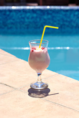 Summer cocktail on the background of the pool. Pina colada, milk cocktail, berry cocktail.