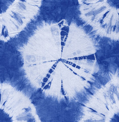 Abstract tie dyed fabric of indigo color on white cotton. Hand painted fabrics. Shibori dyeing