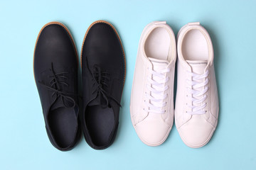 men's office shoes and sneakers on a colored background top view. men's shoes, choice.