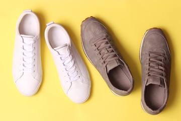 male sneakers and sneakers on a colored background top view. men's footwear. minimalism