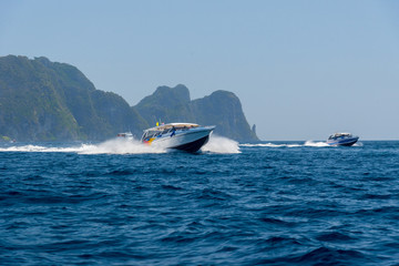 Motor boat and island in the sea