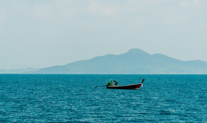 Fototapeta na wymiar Motor boat and island in the sea
