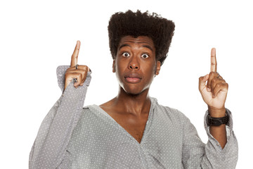 young handsome afro american hipster guy pointing up isolated on white background. people idea...