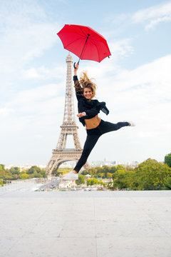 Fashion woman jump with umbrella. Happy woman travel in paris, france. Girl with beauty look at eiffel tower. Travelling and wanderlust. Parisian isolated on white background. Enjoy summer vacation