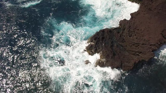 aerial view of ocean coastline - waves washing up on a rock, Hawaii
