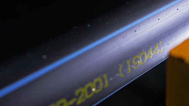 Laser Marking Machine Engraving Powder Paint. Manufacture of plastic water pipes of the factory. Process of making plastic tubes on the machine tool with the use of water and air pressure. Slow motion
