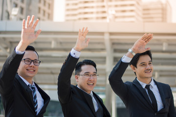 Businessmen are waving to greet