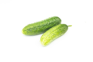 Two whole fresh green ripe cucumbers, salad ingredient, object isolated on white background