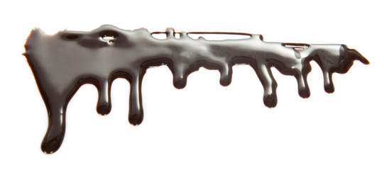 Flows of melted chocolate of bizarre shape isolated on white