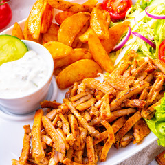 gyros plate it green salad ,olives and potato wedges