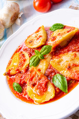 Delicious pasta - ravioli in tomato sauce with basil