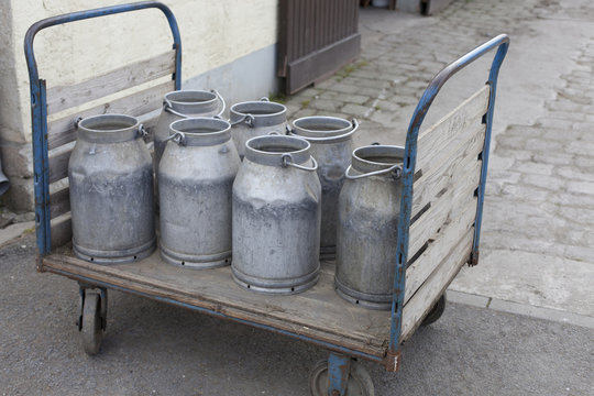old, metal milk cans on trolley