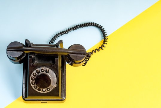 Vintage telephone on a colorful bachground