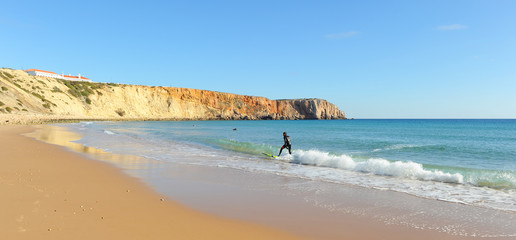 Surfer in Sagres. Bathed by the Atlantic Ocean is one of the most visited by European tourism. Algarve, south of Portugal.