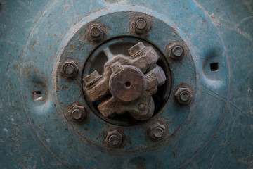 old hub of the tractor wheel with rusty bolts and nuts. Wheel center of tractor