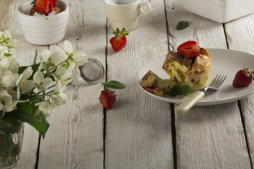 Cottage cheese casserole in white dish decorated with strawberries