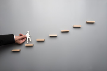 Businessman climbing the ladder of success