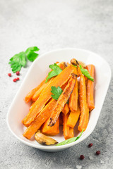 Garlic honey roasted carrots. Selective focus, space for text.
