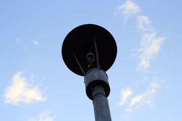 Old rusty lantern on the sky background