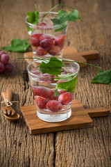 grape fruit with glass on wood