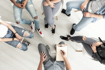 Top view of a group therapy session for teenagers struggling with depression - obrazy, fototapety, plakaty