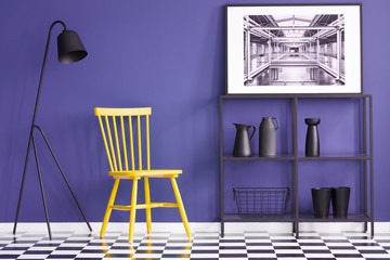 Yellow chair, black lamp, metal shelf, vases and painting set on a violet wall