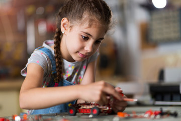 Small girl making a robot
