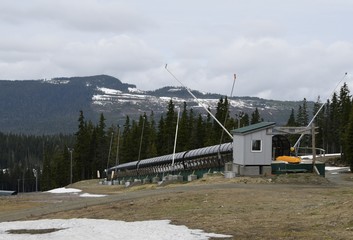 Fototapeta na wymiar ski lift area at Mount Washington in the spring, minimal snow off season ski hill; Vancouver Island BC Canada 