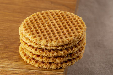 Wafers stacked in a pyramid on a wooden table. Copy space.