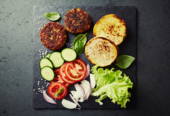 Ingredients for home made burgers on black slate. Flat lay. Home made food