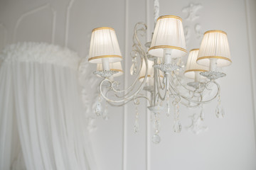 vintage white chandelier in the bedroom