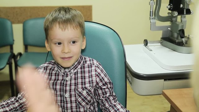 Boy checks eyesight in modern ophthalmological clinic. Eye Gymnastics