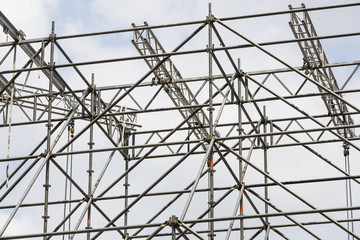 Background of metal construction of a portable concert stage with illuminators. 