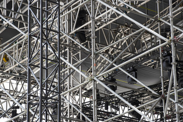 Background of metal construction of a portable concert stage with illuminators. 