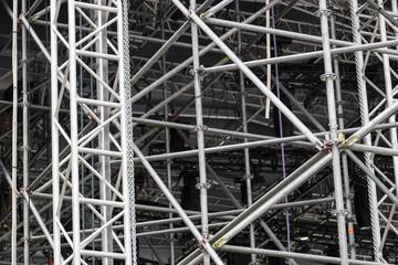 Background of metal construction of a portable concert stage with illuminators. 
