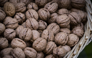 Background of a walnut in a wicker basket close-up 