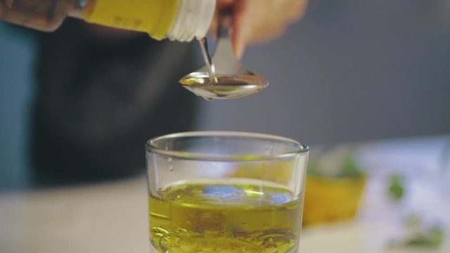 Detail of Olive Oil Measured in a Spoon for Salad Dressing