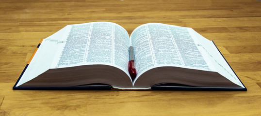 Open book on the background of books.