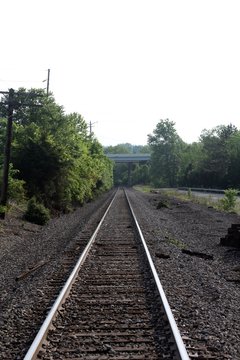 The long railroad tracks in the countryside. 