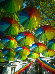 Fototapeta na wymiar To prepare the Gay Pride in Paris, dozens of umbrellas in the colors of the rainbow were hung.