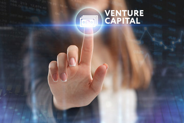 The concept of business, technology, the Internet and the network. A young entrepreneur working on a virtual screen of the future and sees the inscription: Venture capital