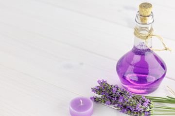 Spa products and lavender flowers on a wooden background