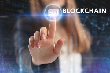 The concept of business, technology, the Internet and the network. A young entrepreneur working on a virtual screen of the future and sees the inscription: blockchain
