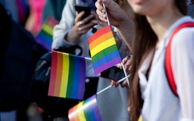 Fototapeta na wymiar crowd waving rainbow flags at pride parade