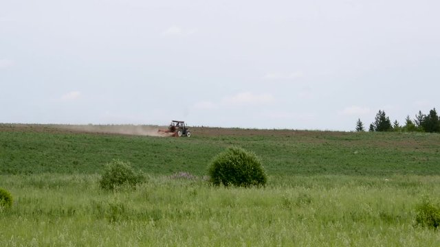 Tractor plows the field. agricultural machinery on a horizon