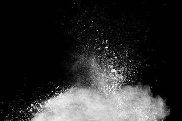 Bizarre forms of  white powder explosion cloud against dark background. Launched white particle splash on black background.