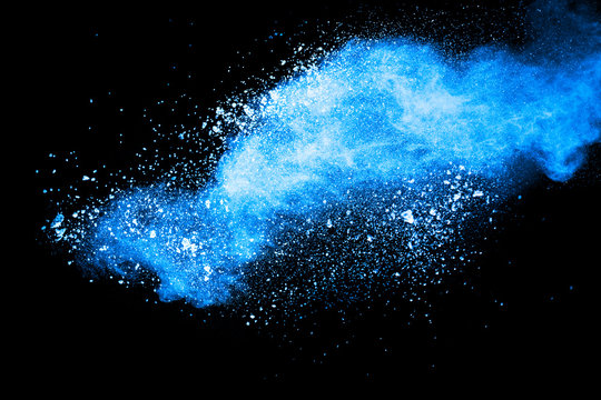 Abstract Blue Dust Explosion On Black Background. Freeze Motion Of Blue Powder Splash. Painted Holi In Festival.