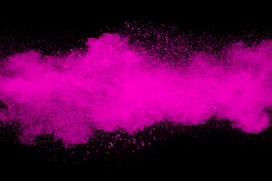 Pink powder explosion isolated on black background.