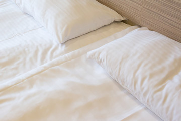 Fototapeta na wymiar Prepared fresh bed, scene in hotel room. Horizontal