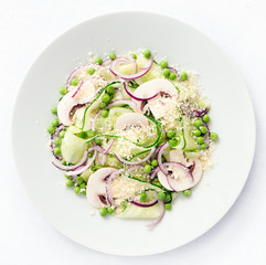 vegetarian salad of cucumber, champinones, onion, and peas dressed with oil and vinegar and sprinkled with cheese